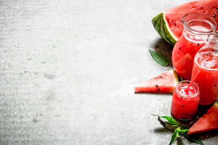 Watermelon juice with mint branches. On the stone table.の写真素材