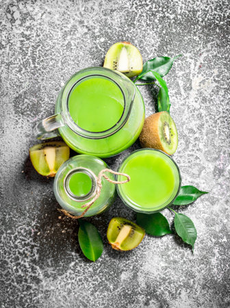 The fresh juice of kiwi. On rustic background.の写真素材