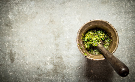 Pesto in a mortar with pestle. On the stone table.の写真素材