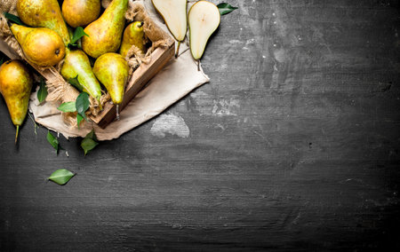Fresh pears in the box. On a black chalkboard.の写真素材