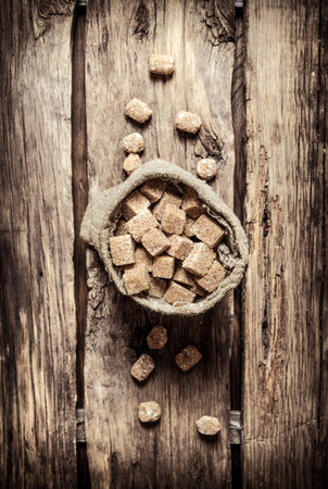 Cane sugar refined in the bag. On the wooden background.の写真素材