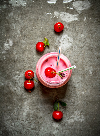 Cherry fresh smoothies . On the stone table.の写真素材