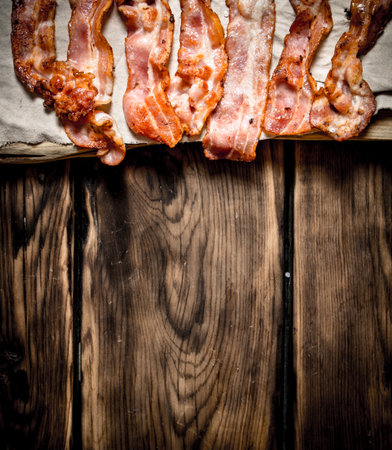 Fried bacon on the fabric. On a wooden table.の写真素材