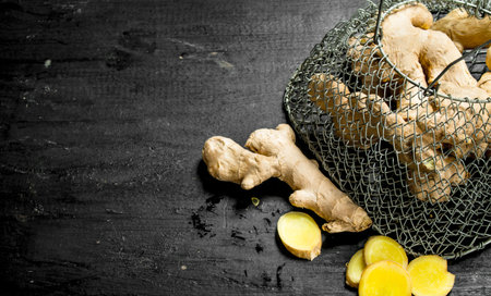 Fresh ginger in mesh bag. On the black chalkboard.の写真素材