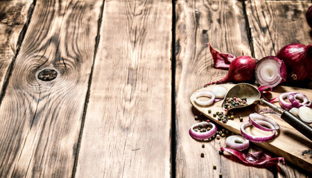 Fresh chopped onion and spices. On wooden background.の写真素材