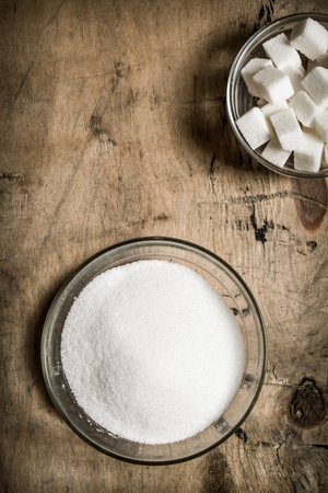 White sugar . On the wooden background. Top viewの写真素材