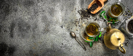 Fresh Indian tea with a brewer. On a rustic background.の写真素材