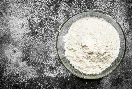 Baking background. Bowl of flour on a rustic background.の写真素材
