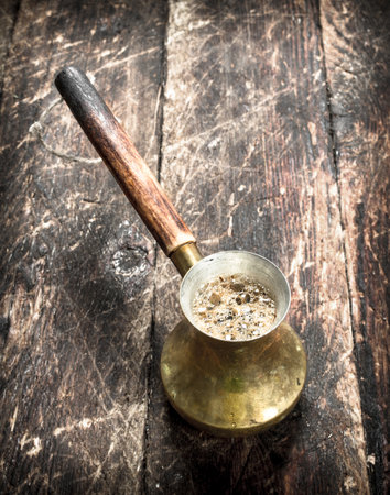 Coffee in turk. On a wooden background.の写真素材