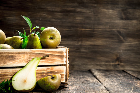 Fresh pears in a box. On a wooden background.の写真素材