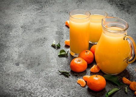 The fresh juice of tangerines. On rustic background.の写真素材