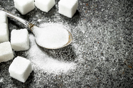 Sugar in a teaspoon. On a rustic background.の写真素材