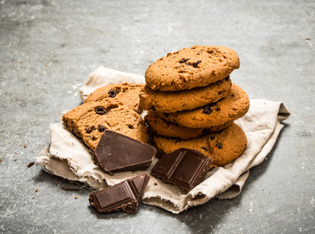 Oat biscuits with chocolate pieces. On the stone table.
