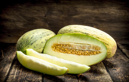 Ripe fresh melon. On a wooden backgroundの写真素材