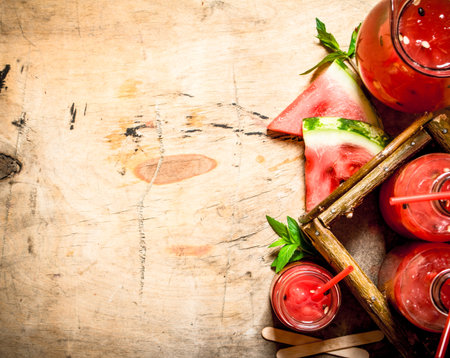 Watermelon juice with pulp. On wooden background.の写真素材