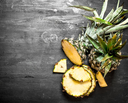 Ripe pineapples. On a black chalkboard. Top viewの写真素材