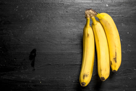 bunch of ripe bananas. On the black chalkboard.の写真素材