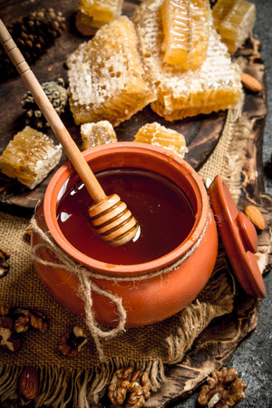 Fresh honey with nuts. On rustic background.の写真素材