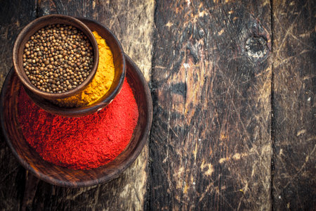 Ground spices in bowls. On a wooden background.の写真素材