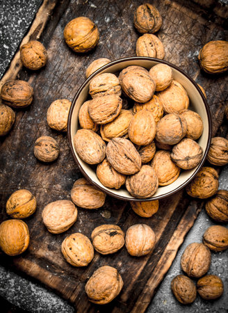 Walnuts in a bowl. On rustic background.