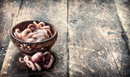 Marinated octopus in a bowl. On a wooden background.の写真素材