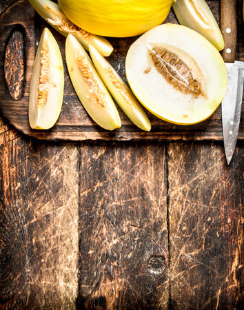 Sliced fresh melon. On the wooden background.の写真素材
