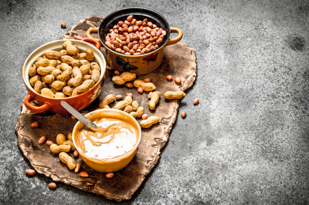 Nuts and peanut butter in a bowl. On rustic background.の写真素材