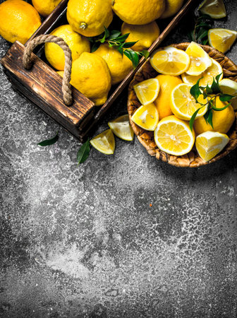 Fresh lemons in a wooden box. On a rustic backgroundの写真素材