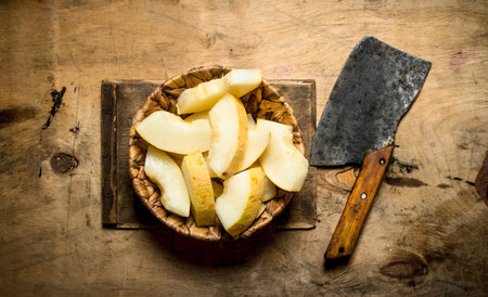 Sliced of ripe melon with an axe. On the wooden table.の写真素材