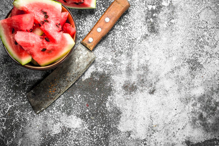Pieces of fresh watermelon in a bowl. On a rustic background.の写真素材