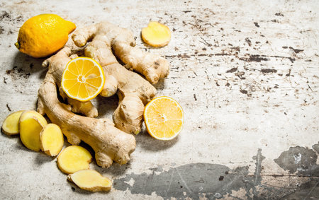 Fresh ginger with lemons. On rustic background.の写真素材
