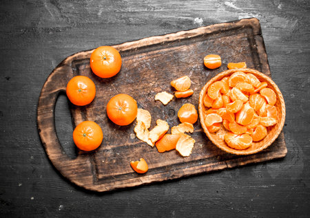 Fresh tangerines in the basket. On a black chalkboard.の写真素材