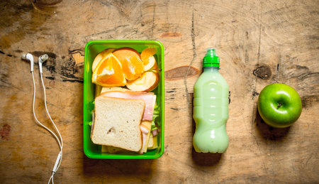 Morning set. Sandwiches with ham and cheese, a milkshake and fruit.の写真素材