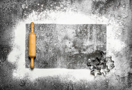 Baking background. A flour frame and dough tools. On a rustic background.の写真素材