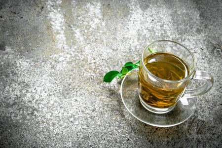 Green tea in a glass cup. On a rustic background.の写真素材