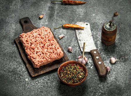 Minced beef with various spices and herbs. On a rustic background.の写真素材