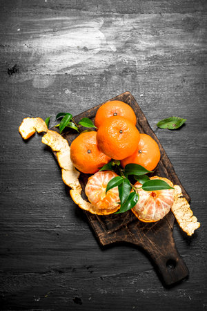 Fresh mandarin with leaves. On the black chalkboard.の写真素材