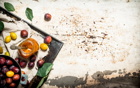 Fresh mashed ripe plums . On rustic background .の写真素材