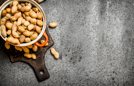 Peanuts in a bowl. On rustic background.