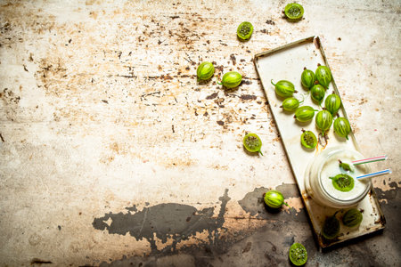 Berry smoothie made from green gooseberries. On rustic background.の写真素材