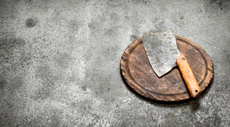 Serving background. Old hatchet on a chopping Board. On rustic background.の写真素材
