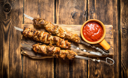 Kebab with tomato sauce. On wooden background.の写真素材