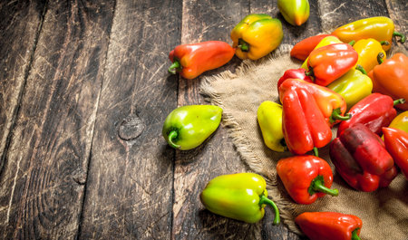 Sweet colorful pepper. On a wooden background.の写真素材