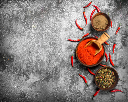 Ground red hot chili peppers in a bowl. On a rustic background.の写真素材