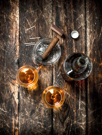 French cognac with a cigar. On a wooden background.の写真素材