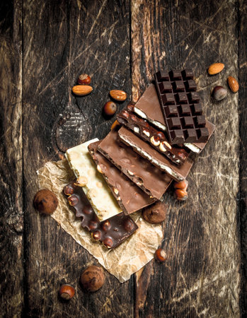 Different types of chocolate. On a wooden background.の写真素材