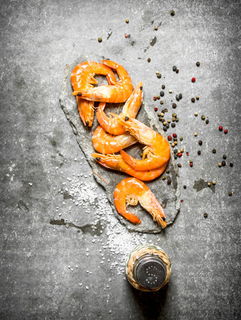 Shrimp with peppercorn and salt. On the stone table.の写真素材