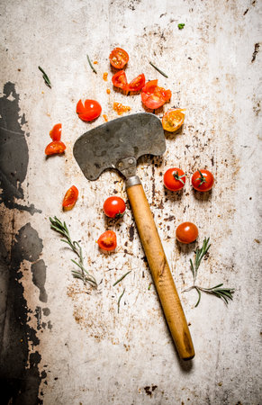Fresh tomatoes with an old knife. On rustic background.の写真素材