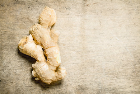 Ginger root. On the wooden backgroundの写真素材