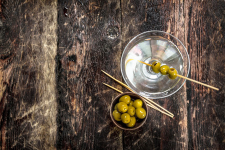 Martini with olives. On a wooden background.の写真素材